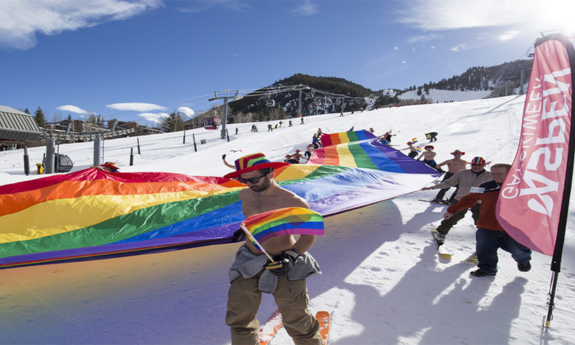 LGBTQ+ individuals and allies from around the world to the snow-covered mountains of Aspen, skiing with the pride flag down Aspen Mountain