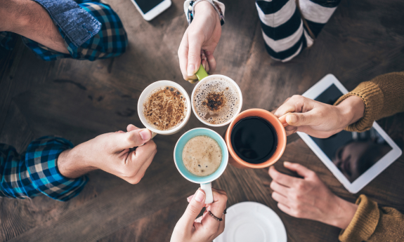 people holding drinks from a café