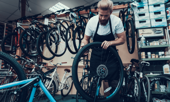Man working in a bike shop on a bicycle 