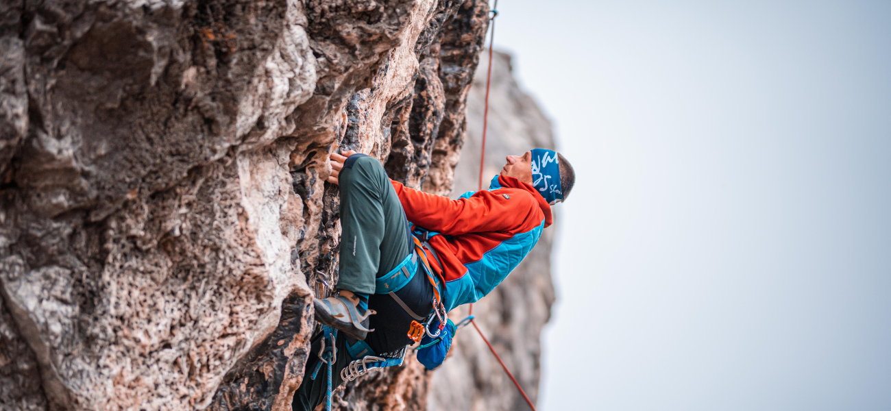 Rock climber scaling the rugged cliffs of Colorado's scenic landscapes